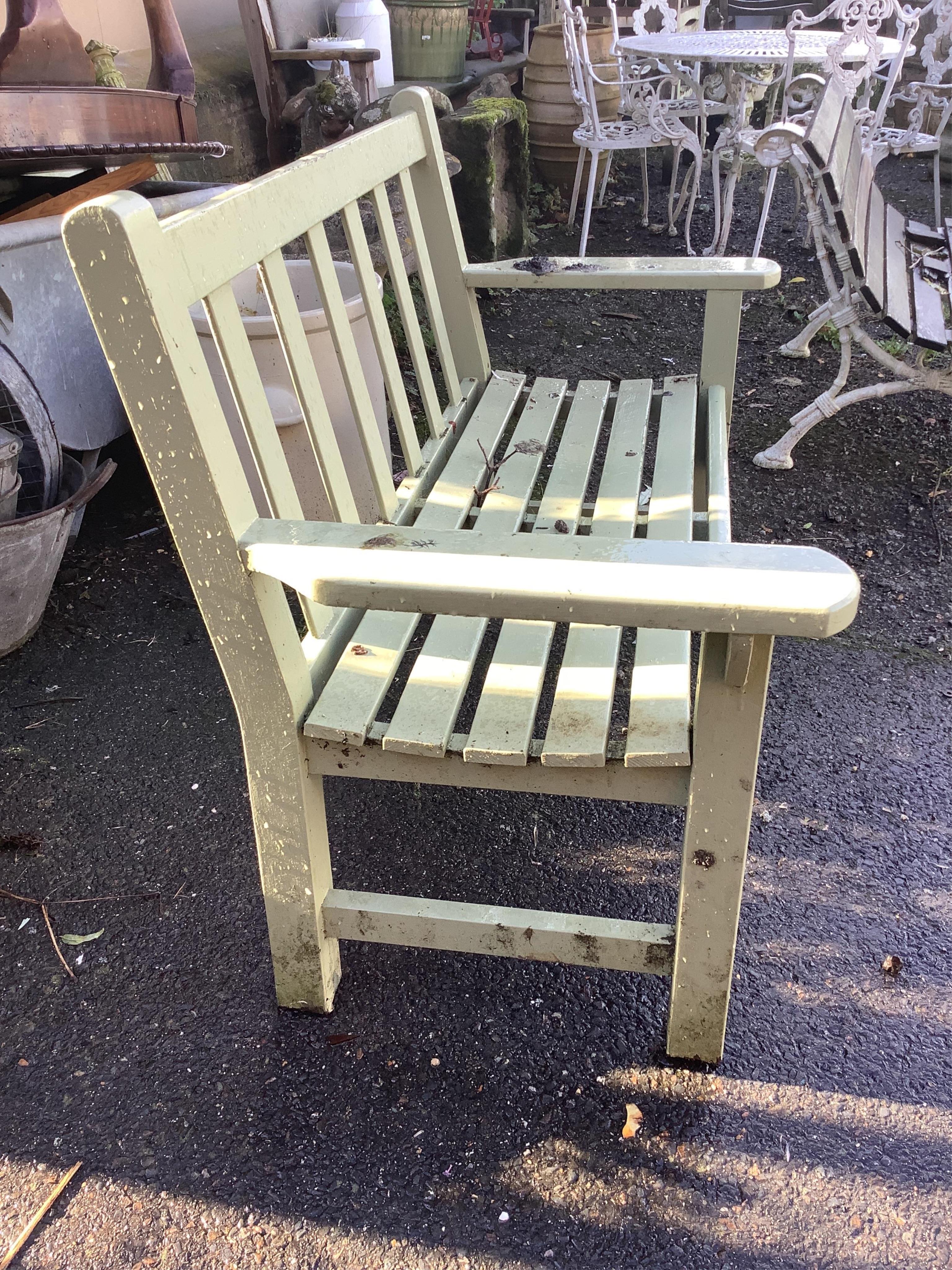 A pale green painted slatted garden bench, width 132cm, depth 62cm, height 89cm. Condition - fair